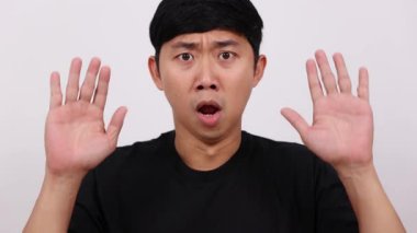 Adam el kaldırır, teslim olur, korkmuş portre hisseder.