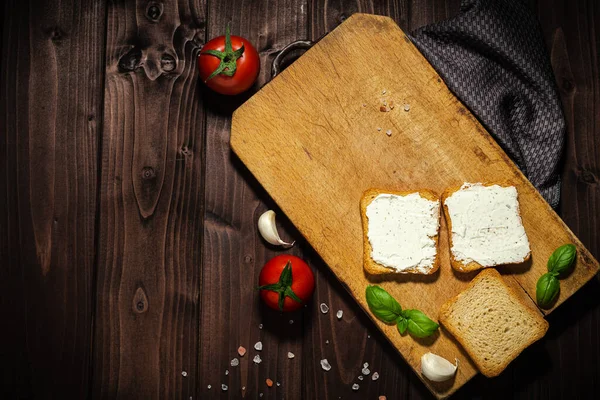 クリームチーズとパンをスライスした朝食写真 木の背景にトマト — ストック写真