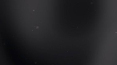 Parlayan parçacıklar siyah gri arkaplanda yüzerler