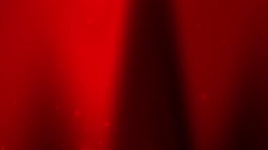 Koyu kırmızı ve siyah renkli arka plan. Noel kutlaması veya modern lüks dijital tasarım projeleri için uygun yumuşak, parlak toz ve bulanık efektler.