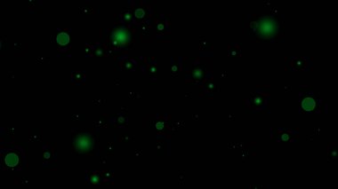 Yeşil parçacık örtüsü siyah arkaplan üzerinde dağınık çemberler oluşturur