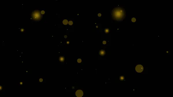 Altın parçacık örtüsü siyah şeffaf arkaplan üzerinde parıldayan sarı halkalar oluşturur