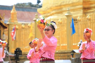 LAMPHUN -THAILAND: November 11, 2023:  Beautiful senior women perform an ancient Thai dance showing dancing in buddhist religious ceremony in TWat Phra That Haripunchai Woramahawihan. Thai nail dance with flower.