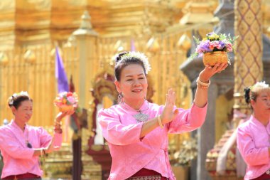 LAMPHUN -THAILAND: November 11, 2023:  Beautiful senior women perform an ancient Thai dance showing dancing in buddhist religious ceremony in TWat Phra That Haripunchai Woramahawihan. Thai nail dance with flower.