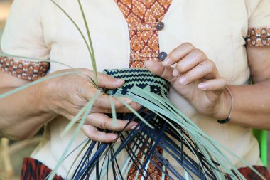 Taylandlı bir kadının eli bambudan bir sepet örüyor. İnsanlar bambudan geleneksel bir sepet örüyorlar.