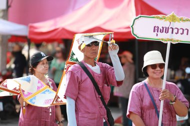 Lampang, Tayland, 13 Nisan 2024: Salung Luang Klong Yai Festivali onuruna düzenlenen Songkran geçit töreninde, geleneksel Lanna kıyafeti giymiş yakışıklı kadın oyuncular ve Hansom erkek aktörler yer aldı..