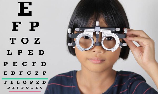 Kid eye test in hospital, child eye exam 