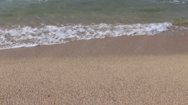 Wave and sand at the tropical beach. Beach slow motion  video