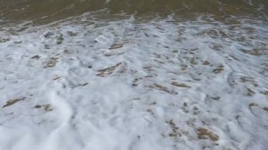 Wave and sand at the tropical beach. Beach slow motion  video