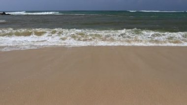 Wave and sand at the tropical beach. Beach slow motion  video
