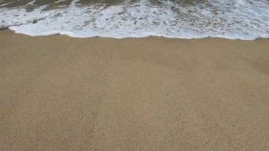 Wave and sand at the tropical beach. Beach slow motion  video