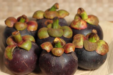 Ahşap arka planda olgun mangosteen meyveleri.