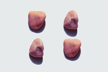 Red stones on a white background, top view, flat lay