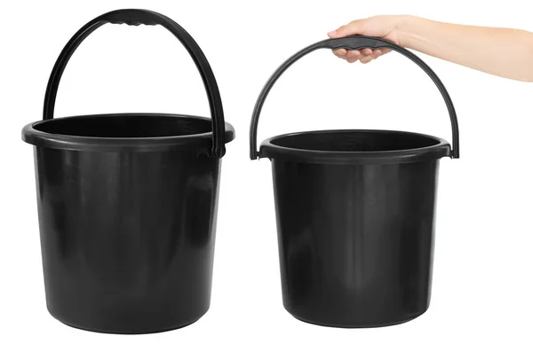 stock image Black plastic bucket in hand. Isolated from the background