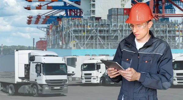 Port manager with a digital tablet against the background of a trucks and ship loaded with containers in the seaport