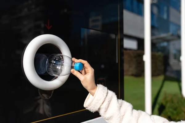 stock image Woman uses a self service machine to receive used plastic bottles and cans on a city street