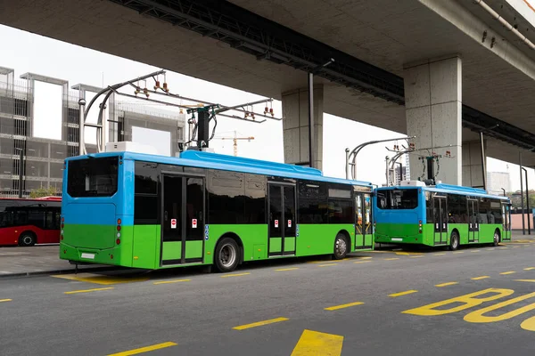 Electric bus at a stop is charged by pantograph