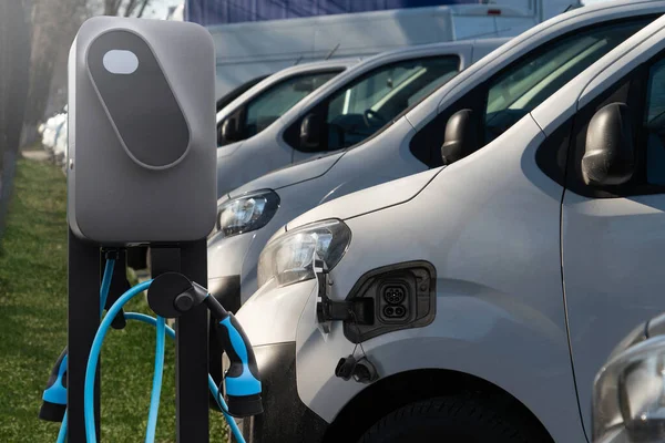 Electric vehicles charging station on a background of a van. Concept