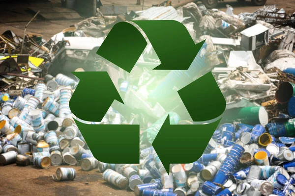 Recycle symbol on a background of metal waste disposal