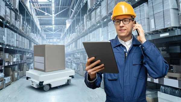 Manager with digital tablet in an automated warehouse
