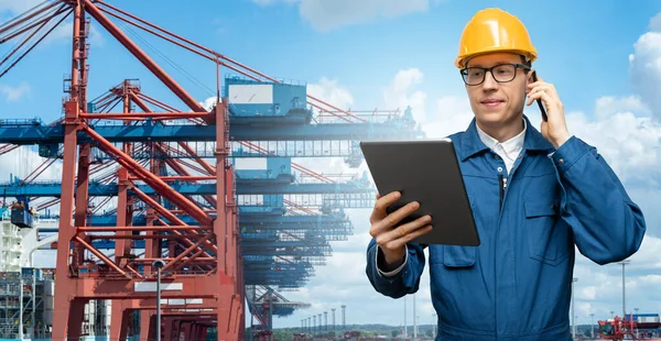 Port manager with digital tablet on a background of a ship loaded with containers in the seaport