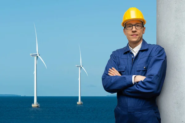 Engineer on a background of wind turbines at sea