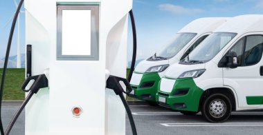 Electric delivery vans with electric vehicles charging station. High quality photo clipart