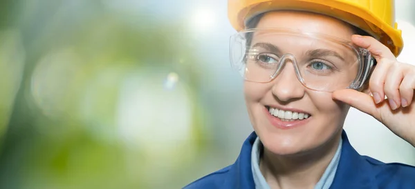 stock image Portrait of a woman engineer in helmet and protective glasses. High quality photo