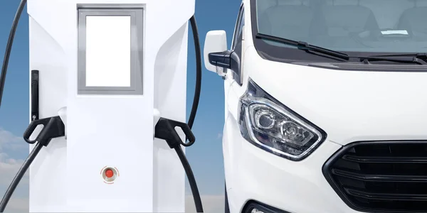 Electric delivery van with electric vehicles charging station. High quality photo