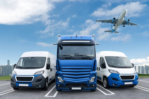 Airplane in the sky above the truck and vans. World trade and transportation concept. High quality photo