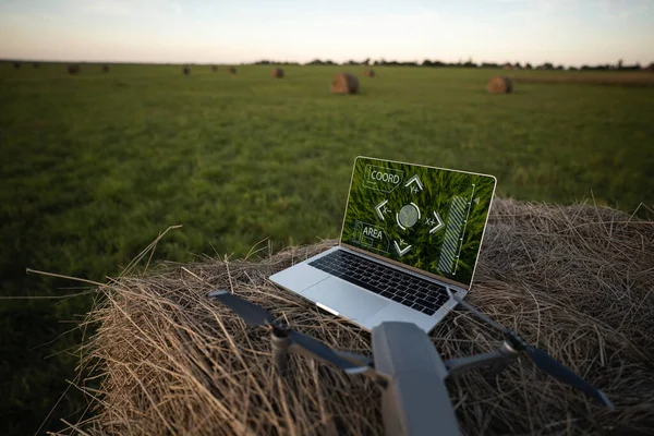 Laptop and drone on the field. Smart farming and agriculture digitalization. High quality photo