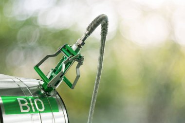 Biofuel filling nozzle with storage tank on a green background. High quality photo clipart