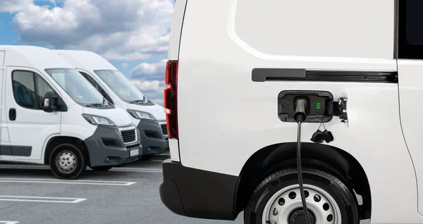 Electric delivery van with connected charging cable. High quality photo