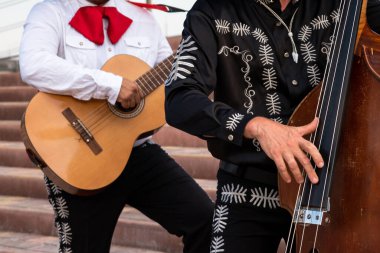 Mexican musician mariachi band on a city street. clipart