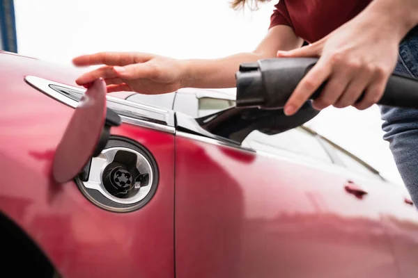 Woman Smartphone Charging Red Electric Car — Stock Photo, Image