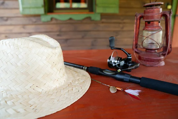 Close Spinning Rod Straw Hat Lantern Mug Wooden Table — Stock Photo, Image