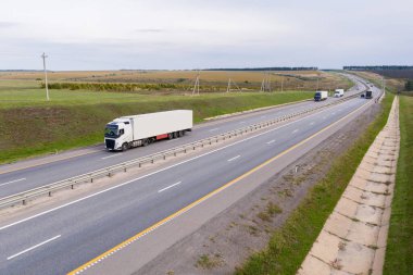 Trucks with trailers on the highway. Aerial view. clipart