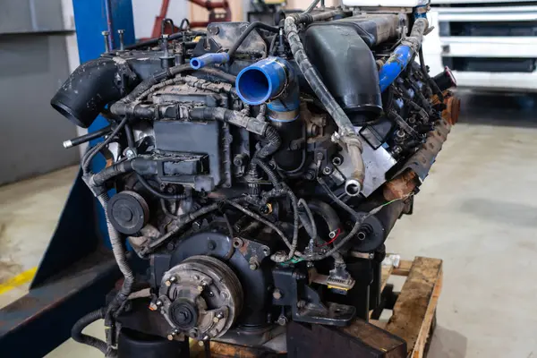 Disassembled engine at a truck repair service.