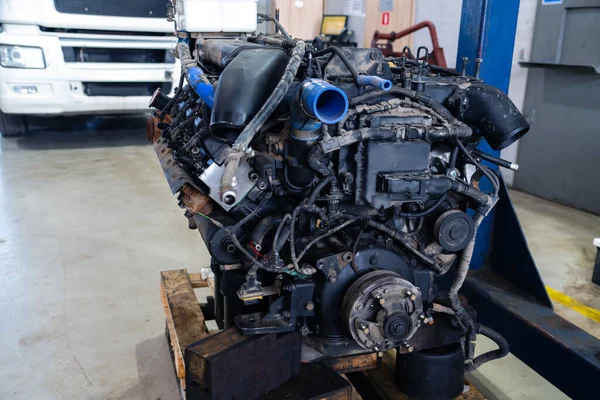 Disassembled engine at a truck repair service.