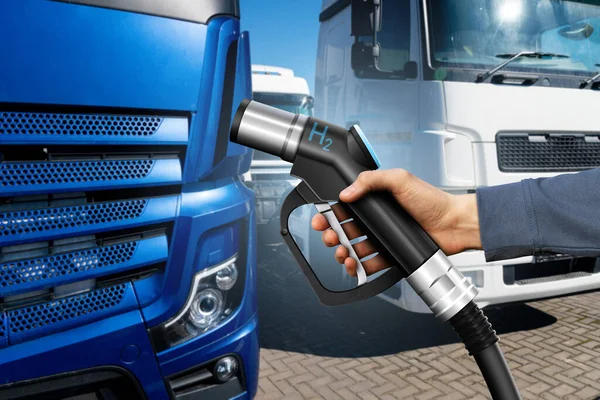 Hand with H2 fueling nozzle on a background of hydrogen fuel cell truck. Eco-friendly commercial vehicle concept.