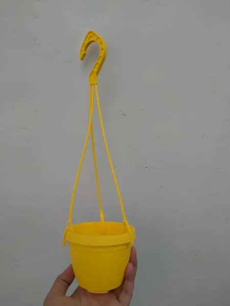 Hand Holding Yellow Hanging Pot White Background — Stock Photo, Image