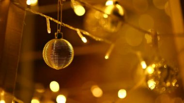 A cozy warm garland and round balls are hung on a homemade Christmas installation for the new year.