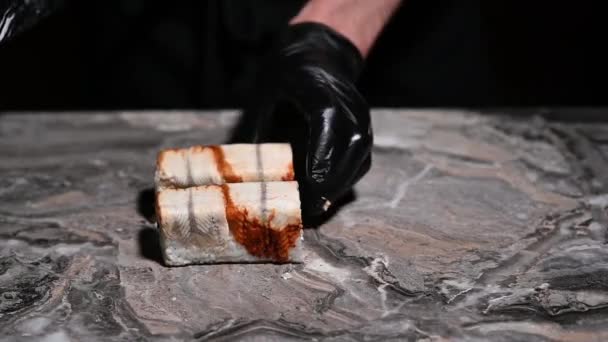 寿司ロールフィラデルフィアを閉じる料理のプロセス 寿司職人は鋭いナイフでロールを切断します 日本の伝統的な魚介類と魚 — ストック動画