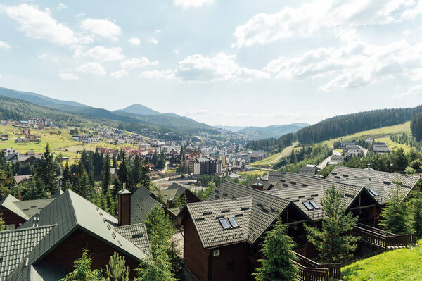A review view of the resort city in the Carpathian mountains. Roofs of houses and mountains look very atmospheric.