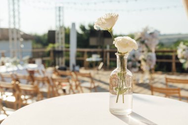 Beautiful flowers decorated on the table.Tables set for an event party or wedding reception. luxury elegant table setting dinner in a restaurant.