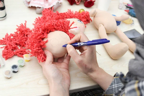 making dolls with the help of cloth and cotton