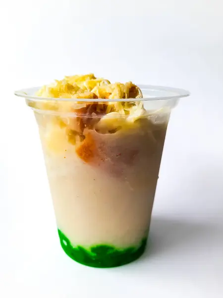 Durian Cendol Ice Drink topped with grated cheese and slices of bread