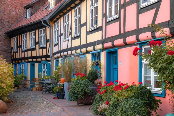 Colourful old houses, build in traditional german wooden stile, decorated abundantly with the flowers, Stralsund, Germany