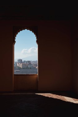 View on Malaga cityscape through the arched window of Alcazaba Palace