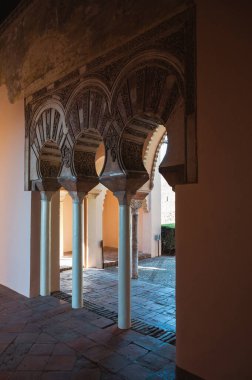 Caliphal-style horseshoe arches at the entrance of the main hall in Taifa Palace, Alcazaba, Malaga, Spain